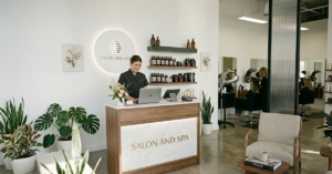 A Modern And Minimalist Salon Reception Area Featuring A Clean, Professional Aesthetic To Illustrate The Professional Brand Image And 10 Reasons You Need Online Booking Benefits For Beauty Businesses.