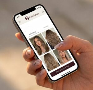 A Manicured Hand Holds A Smartphone Displaying The Elegant, Visual-First Portfolio Interface Of The Fully-Branded Glowhives Platform, Featuring The Exact Corrected &Quot;Glowhives&Quot; Text Next To The Hexagonal Logo In The Header.